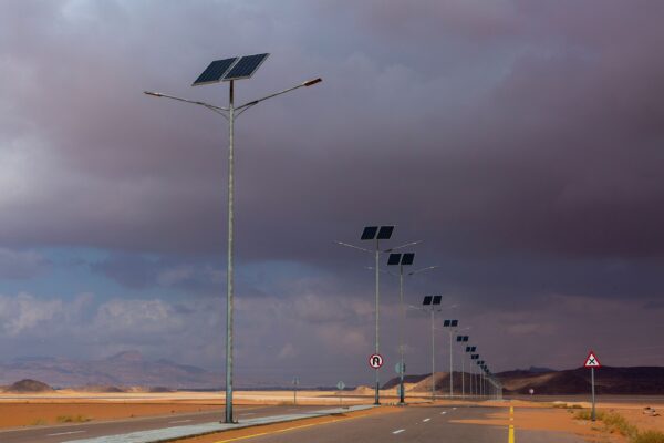 Solar panels along a desert road.